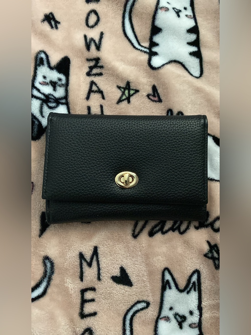 Black medium wallet with gold hardware.